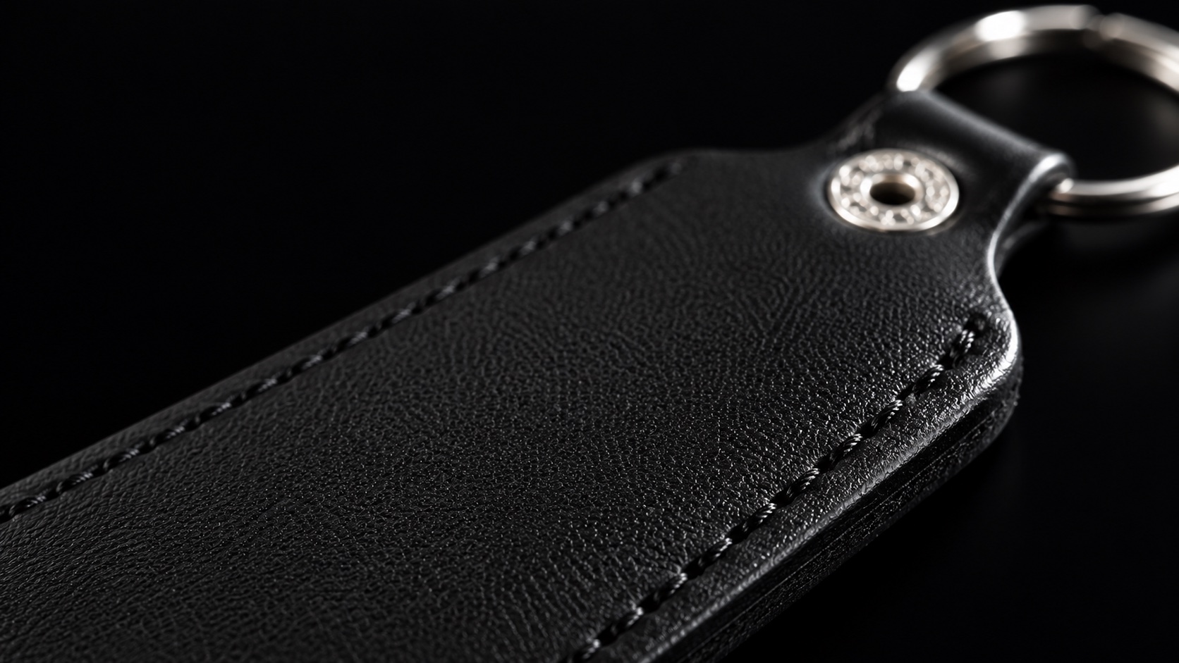 Detail visualization of the black PU surface, stitching and edge of an RFID keyfob.